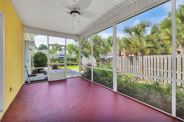 unfurnished sunroom with ceiling fan