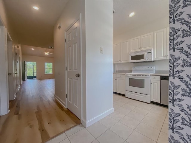 348 Moss Creek Ln, Brunswick, GA 31522 - kitchen featuring white appliances, white cabinets, light countertops, light tile patterned flooring, and recessed lighting