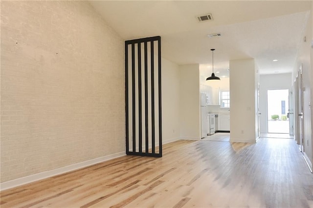 348 Moss Creek Ln, Brunswick, GA 31522 - empty room with light wood-style floors and brick wall