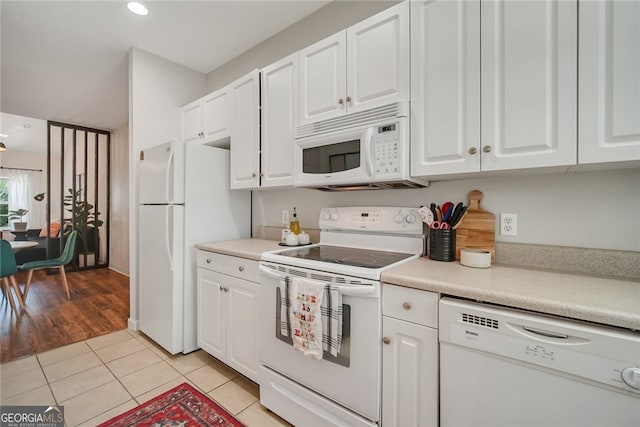 348 Moss Creek Ln, Brunswick, GA 31522 - kitchen with white appliances, white cabinetry, light tile patterned flooring, light countertops, and recessed lighting