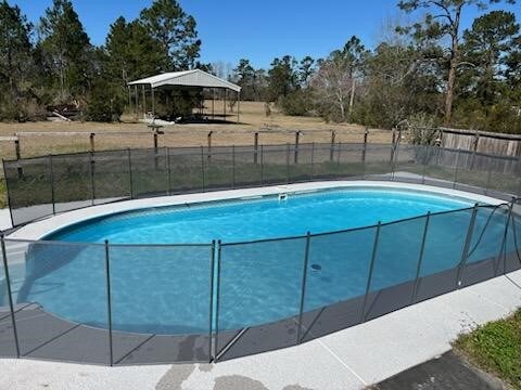 3015 Brannen Rd, Waycross, GA 31501 - view of swimming pool featuring fence and view of scattered trees
