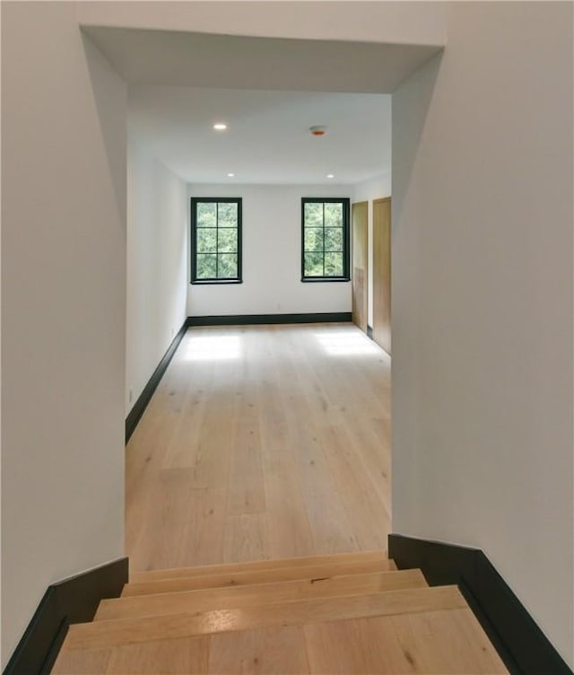 corridor with light hardwood / wood-style flooring