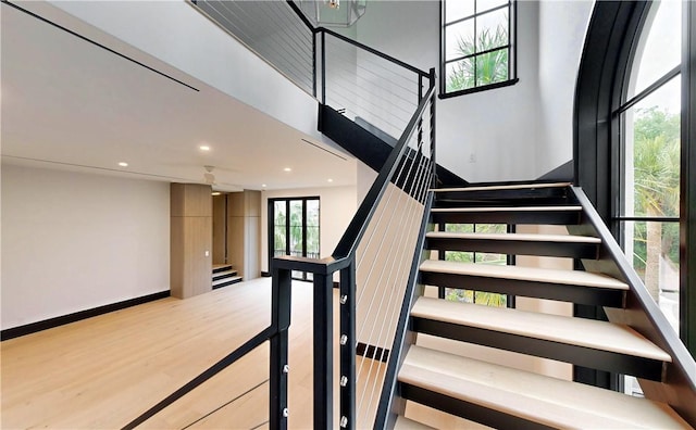 stairs featuring hardwood / wood-style flooring