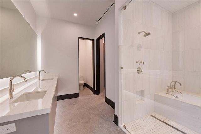 bathroom with vanity, an enclosed shower, and toilet