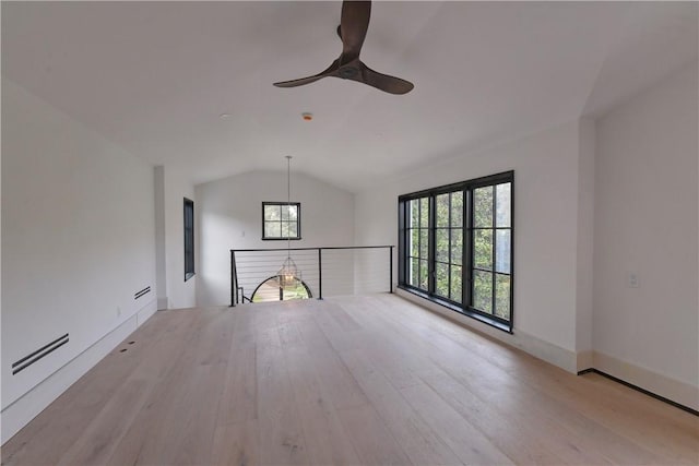 unfurnished living room featuring ceiling fan, light hardwood / wood-style floors, and lofted ceiling