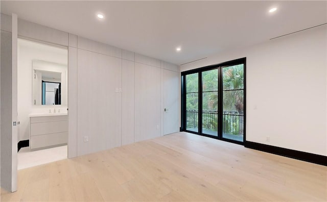 empty room with light hardwood / wood-style flooring and sink