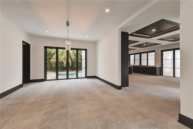 unfurnished room featuring beamed ceiling, a chandelier, and coffered ceiling