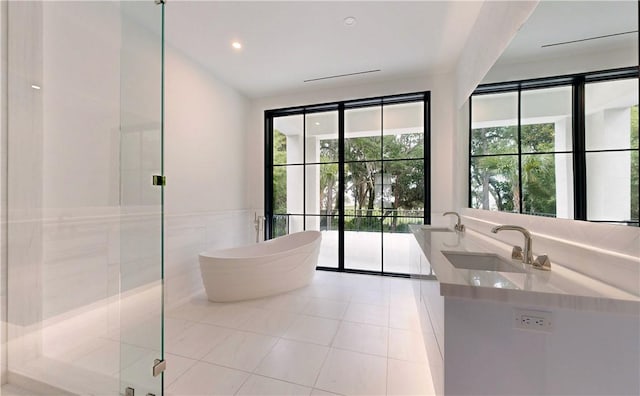 bathroom featuring tile patterned floors, separate shower and tub, and vanity