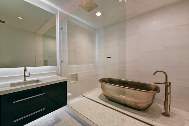 bathroom featuring tile patterned floors, vanity, and tile walls