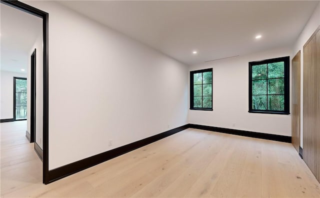 spare room with light hardwood / wood-style flooring