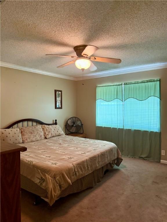 101 Brighton Cir, Brunswick, GA 31525 - carpeted bedroom featuring crown molding, a textured ceiling, and ceiling fan