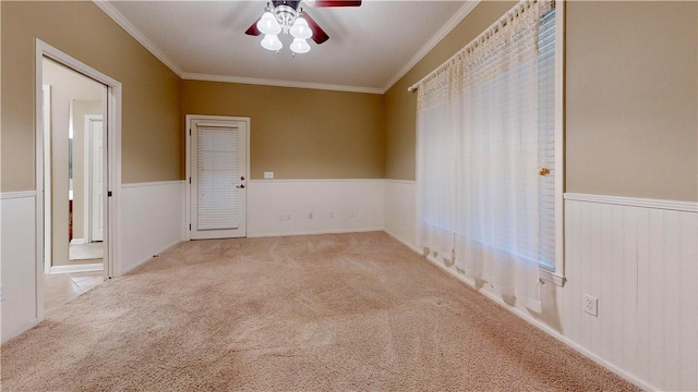5577 Strickland Rd, Waycross, GA 31503 - carpeted empty room featuring crown molding, ceiling fan, and wainscoting