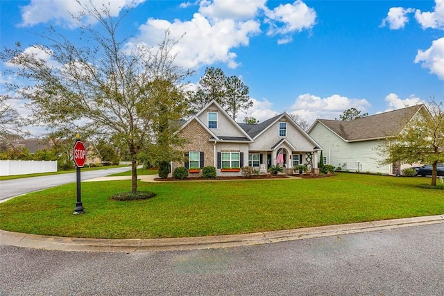 view of front of property featuring a front lawn and fence