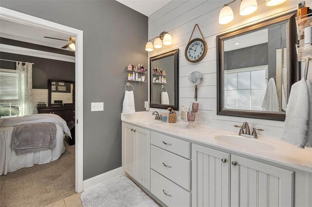 bathroom featuring double vanity, tile patterned floors, ceiling fan, and a sink