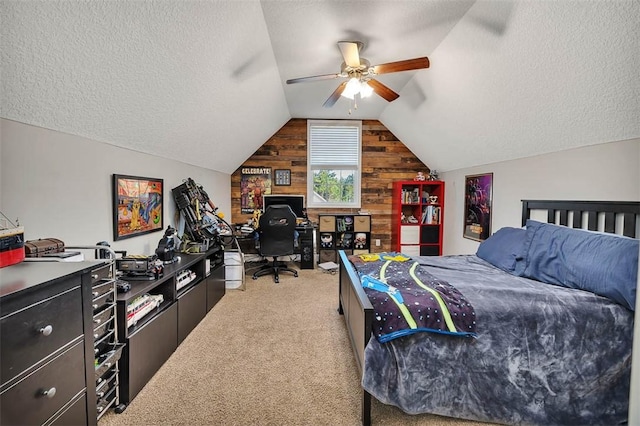 bedroom featuring light colored carpet, wood walls, a textured ceiling, and lofted ceiling