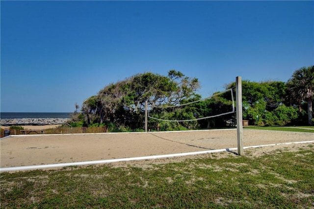 surrounding community featuring a water view, a yard, and volleyball court