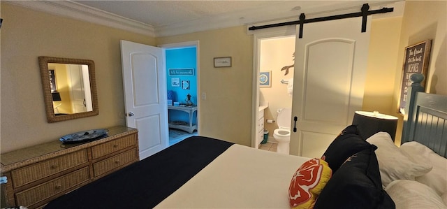 bedroom featuring crown molding, a barn door, and connected bathroom