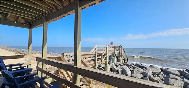 exterior space with a water view and a view of the beach