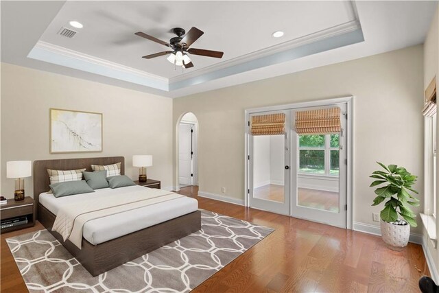 114 Wedge Wood Ct, Brunswick, GA 31525 - bedroom featuring a raised ceiling, wood finished floors, arched walkways, crown molding, and recessed lighting