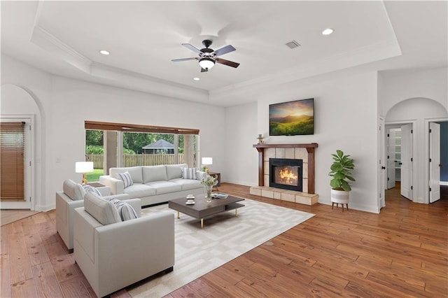114 Wedge Wood Ct, Brunswick, GA 31525 - living room with a raised ceiling, arched walkways, light wood-type flooring, recessed lighting, and ornamental molding