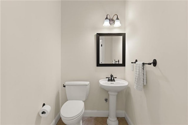 114 Wedge Wood Ct, Brunswick, GA 31525 - half bathroom with baseboards, toilet, tile patterned flooring, and a sink