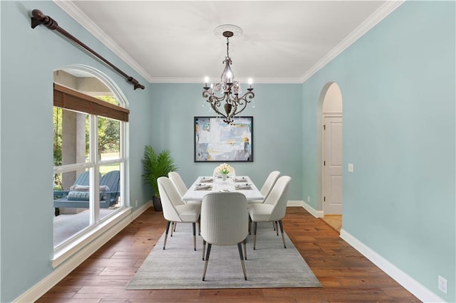 114 Wedge Wood Ct, Brunswick, GA 31525 - dining room with a chandelier, arched walkways, ornamental molding, baseboards, and wood finished floors