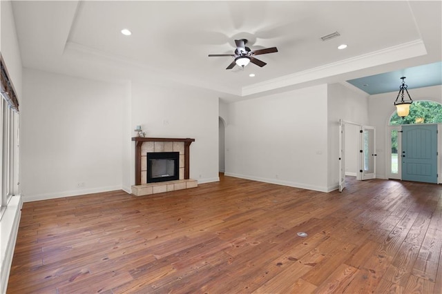 114 Wedge Wood Ct, Brunswick, GA 31525 - unfurnished living room with a tray ceiling, hardwood / wood-style floors, ceiling fan, recessed lighting, and crown molding