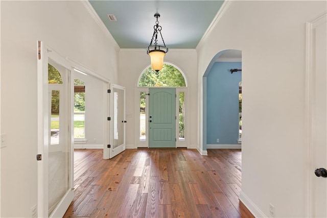 114 Wedge Wood Ct, Brunswick, GA 31525 - foyer featuring healthy amount of natural light, arched walkways, wood-type flooring, crown molding, and baseboards