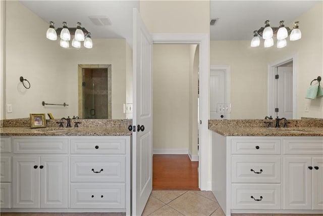 114 Wedge Wood Ct, Brunswick, GA 31525 - bathroom featuring tile patterned floors, two vanities, and a stall shower