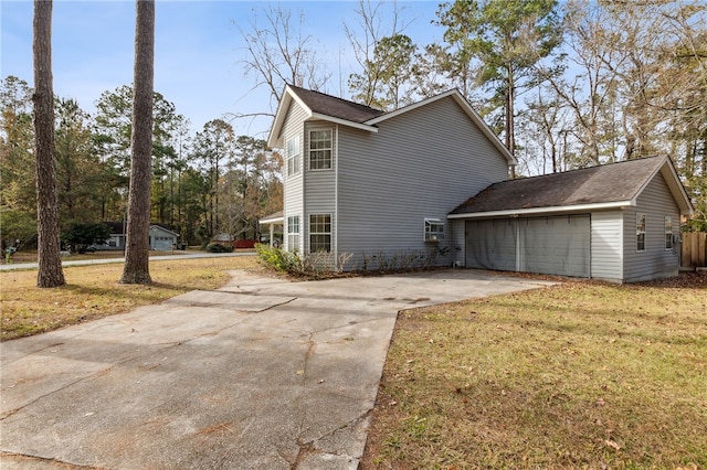 view of side of property with a yard and a garage