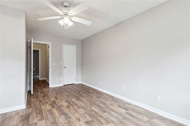 unfurnished bedroom featuring a textured ceiling, hardwood / wood-style flooring, and ceiling fan