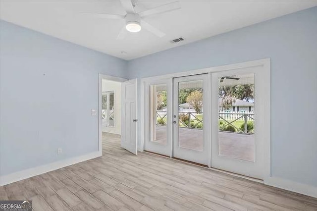 unfurnished room with french doors, light hardwood / wood-style flooring, a wealth of natural light, and ceiling fan