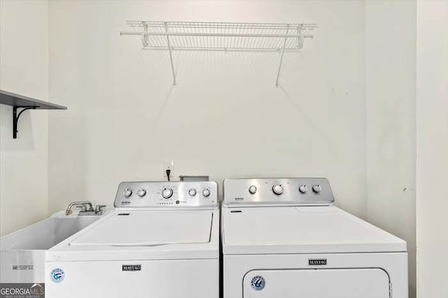 laundry area with washer and clothes dryer and sink