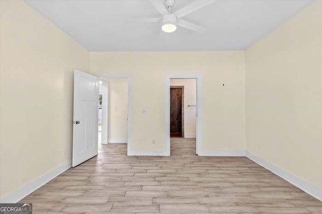 unfurnished room with ceiling fan and light wood-type flooring