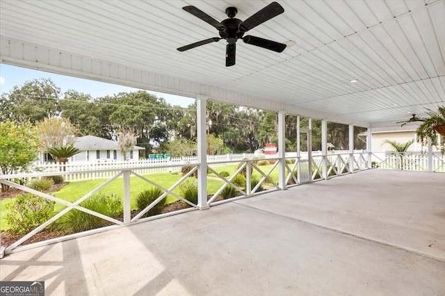 unfurnished sunroom with ceiling fan