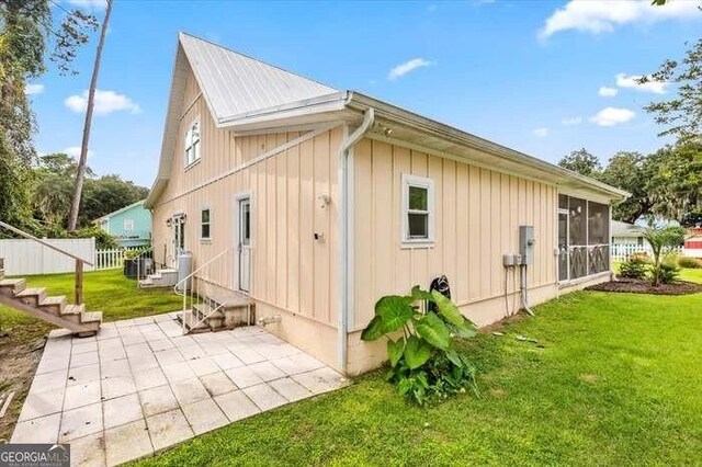 view of property exterior with a patio area and a yard