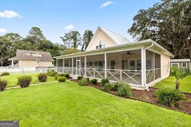 back of property featuring a yard, ceiling fan, and a sunroom