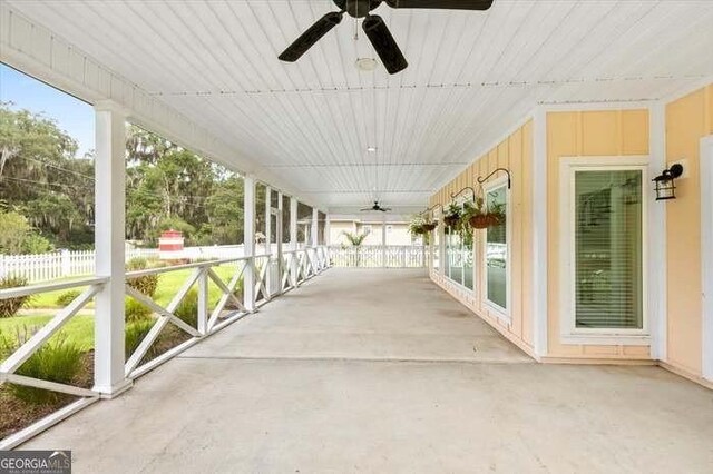 unfurnished sunroom featuring ceiling fan