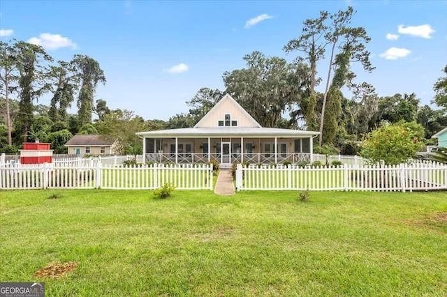 farmhouse featuring a sunroom and a front yard