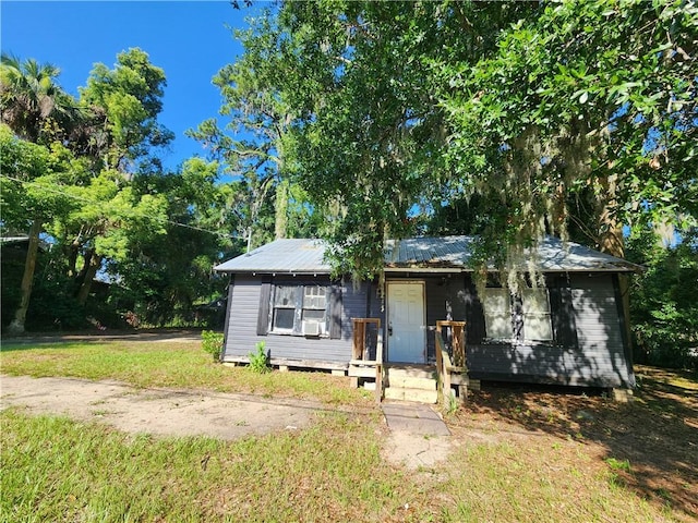2817 Ellis St, Brunswick, GA 31520 - view of front of home with a metal roof and a front lawn