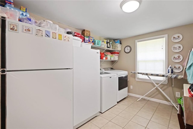 314 King David Rd, Jesup, GA 31545 - kitchen featuring freestanding refrigerator, washer and dryer, light tile patterned floors, white cabinetry, and light countertops
