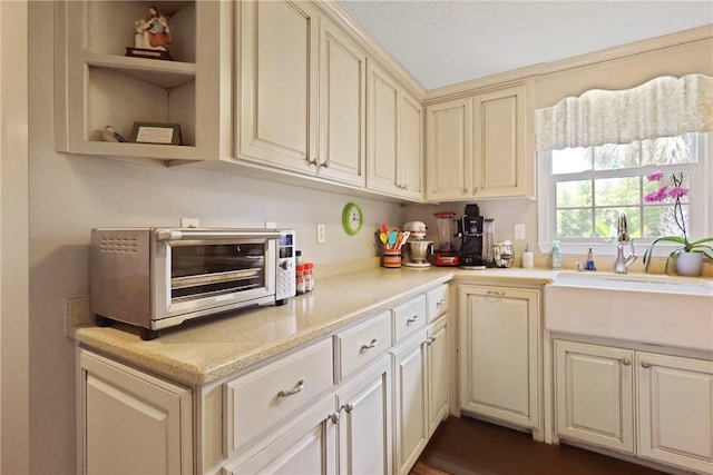 314 King David Rd, Jesup, GA 31545 - kitchen featuring light countertops, cream cabinets, and open shelves