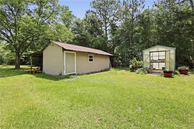 314 King David Rd, Jesup, GA 31545 - view of grassy yard featuring a storage unit and view of wooded area