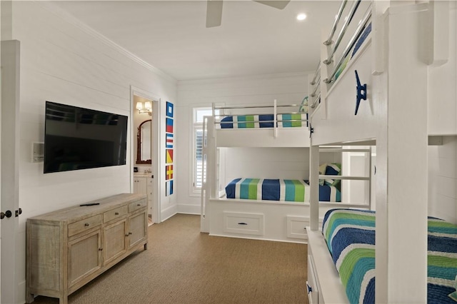 bedroom featuring ensuite bathroom, ceiling fan, ornamental molding, and light carpet