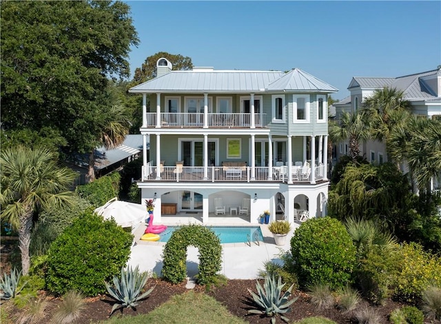 back of house featuring a patio area and a balcony