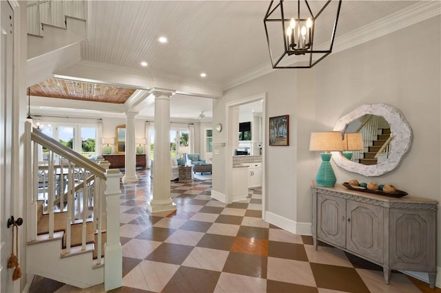 entrance foyer with wooden ceiling, crown molding, a wealth of natural light, and decorative columns