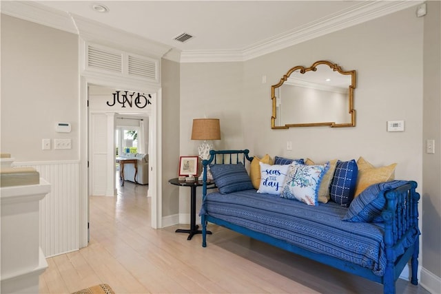 living room with hardwood / wood-style floors and ornamental molding