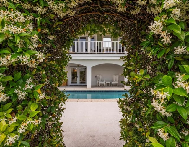 view of pool with a patio area and french doors