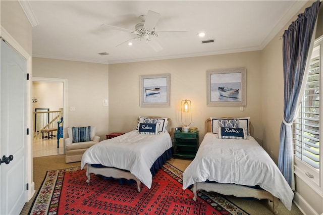 bedroom featuring ceiling fan, ornamental molding, and carpet floors