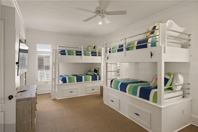 carpeted bedroom with ceiling fan and ornamental molding